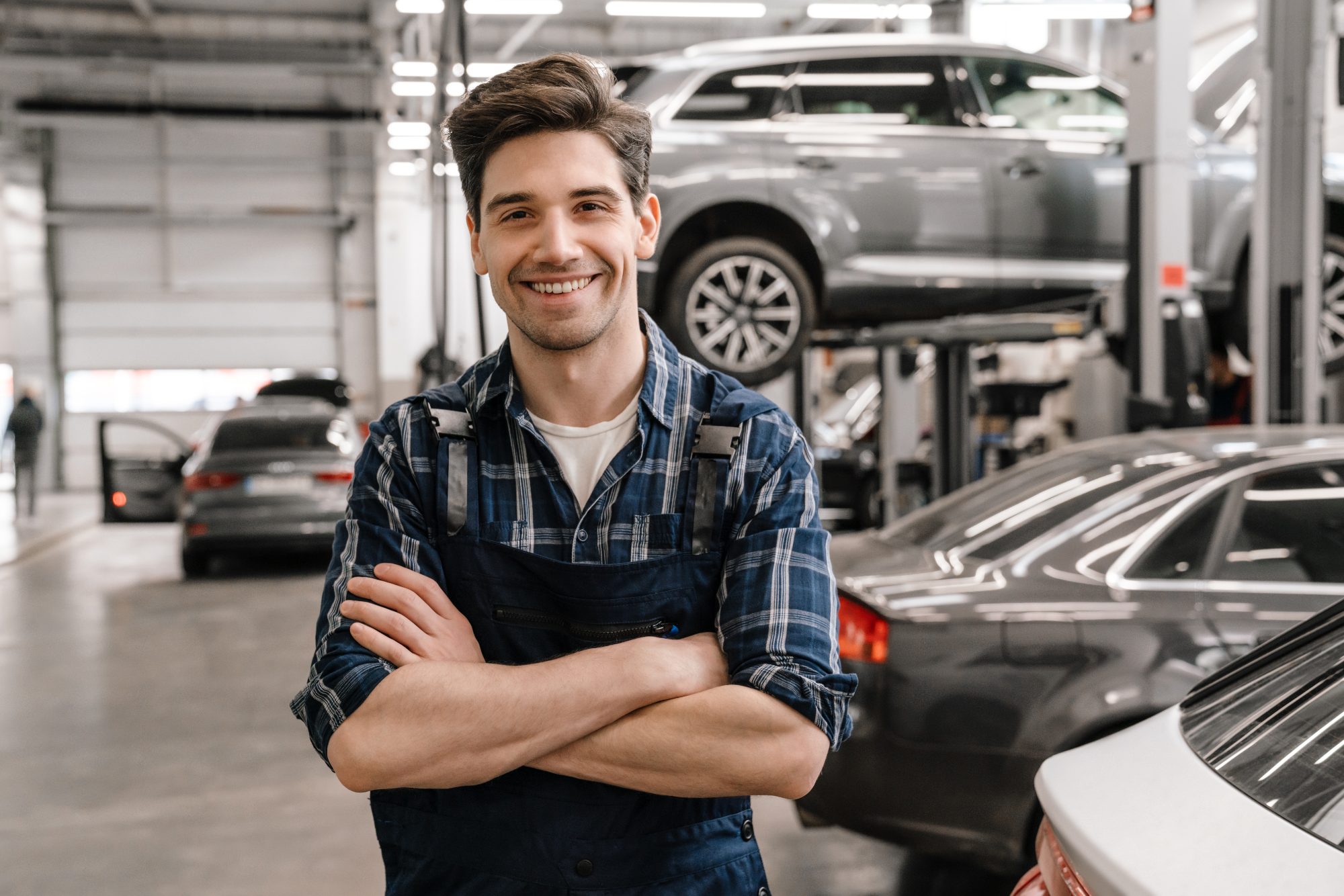 A mechanic in a busy MOT workshop